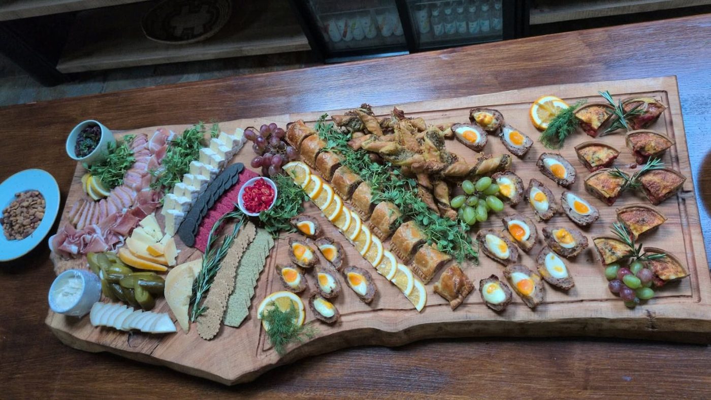 The ash serving board from above, showing its live edge and juice groove