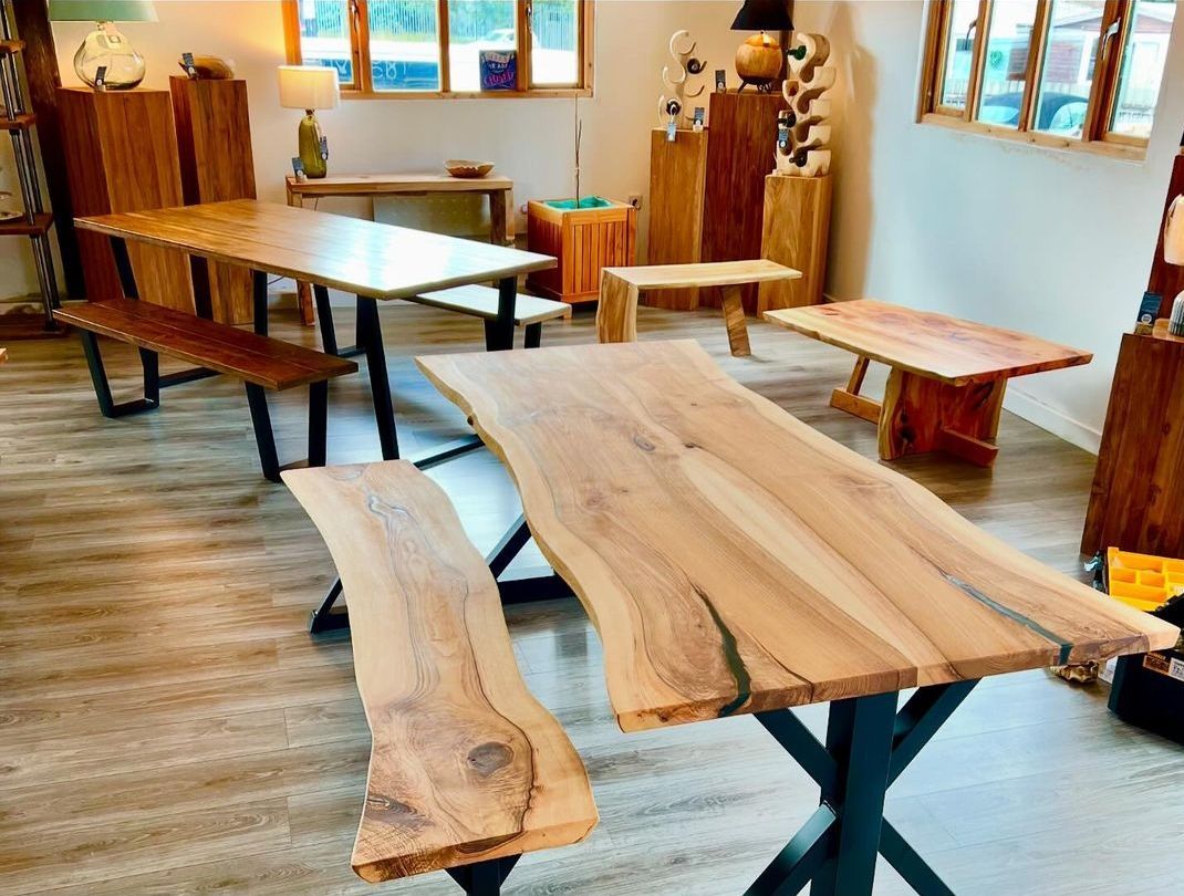 Live-edge tables and benches in a showroom