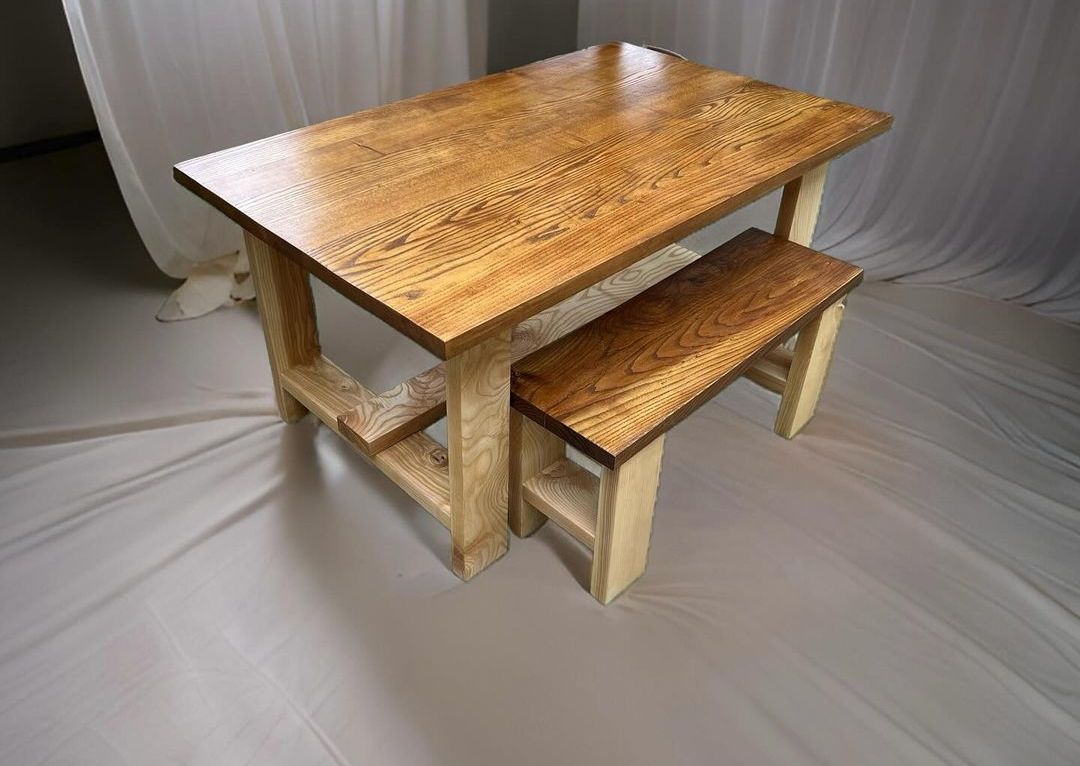 A solid ash dining table with a matching bench